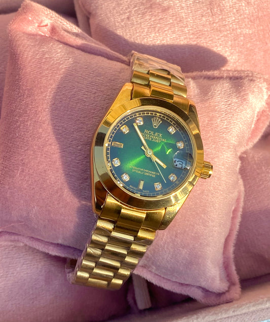 Emerald dial stone studded watch