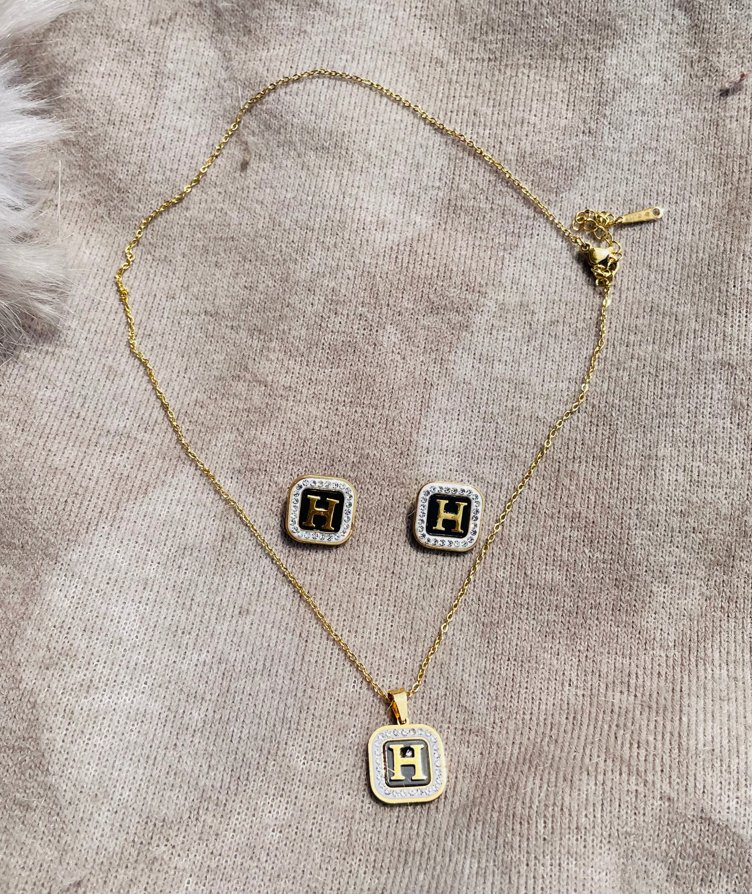 Black enamel diamantés H initial pendant and tops set